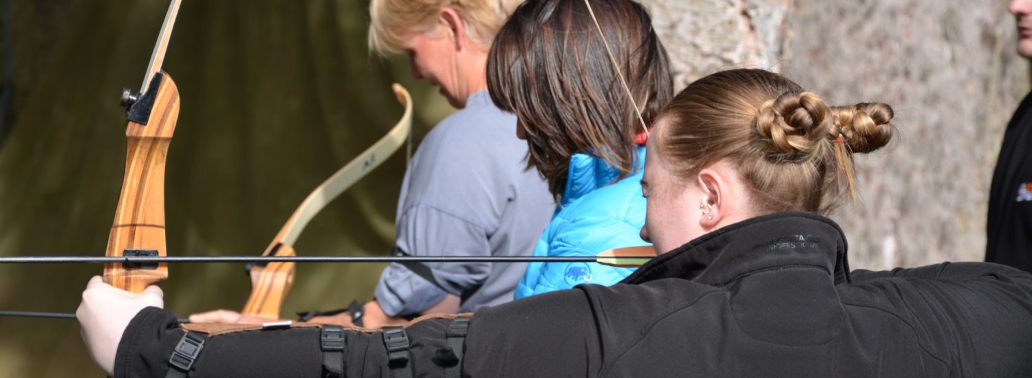 Veterinary professionals participating in archery at an XLVets National Meeting