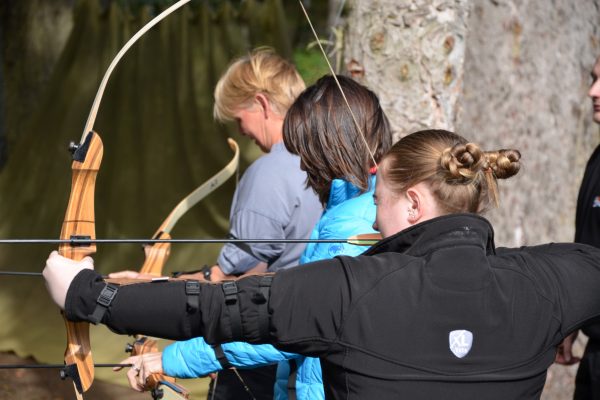 Veterinary professionals participating in archery at an XLVets National Meeting