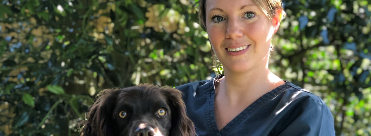 Photo shows Lyndsay Hughes holding a Spaniel